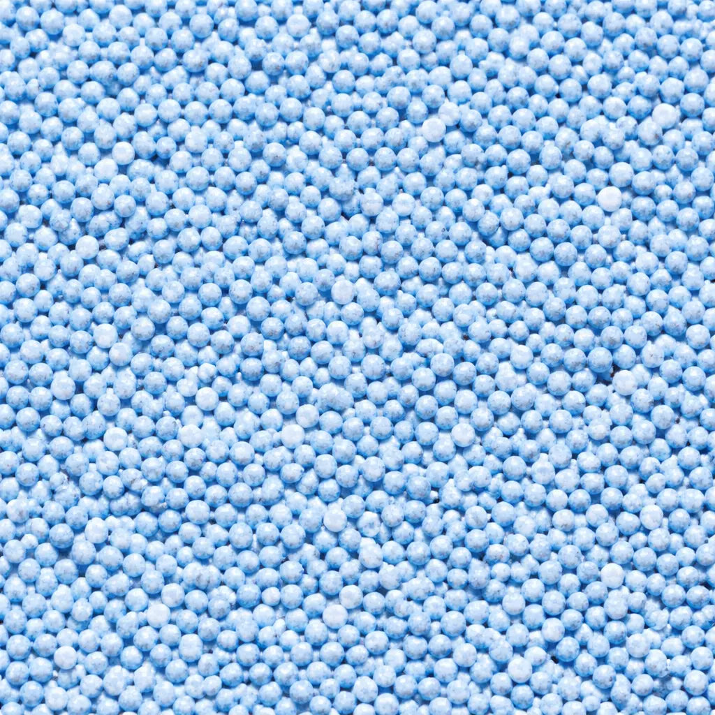 Close-up view of blue transplant shock reducer fertiliser granules designed to help hedges establish after planting